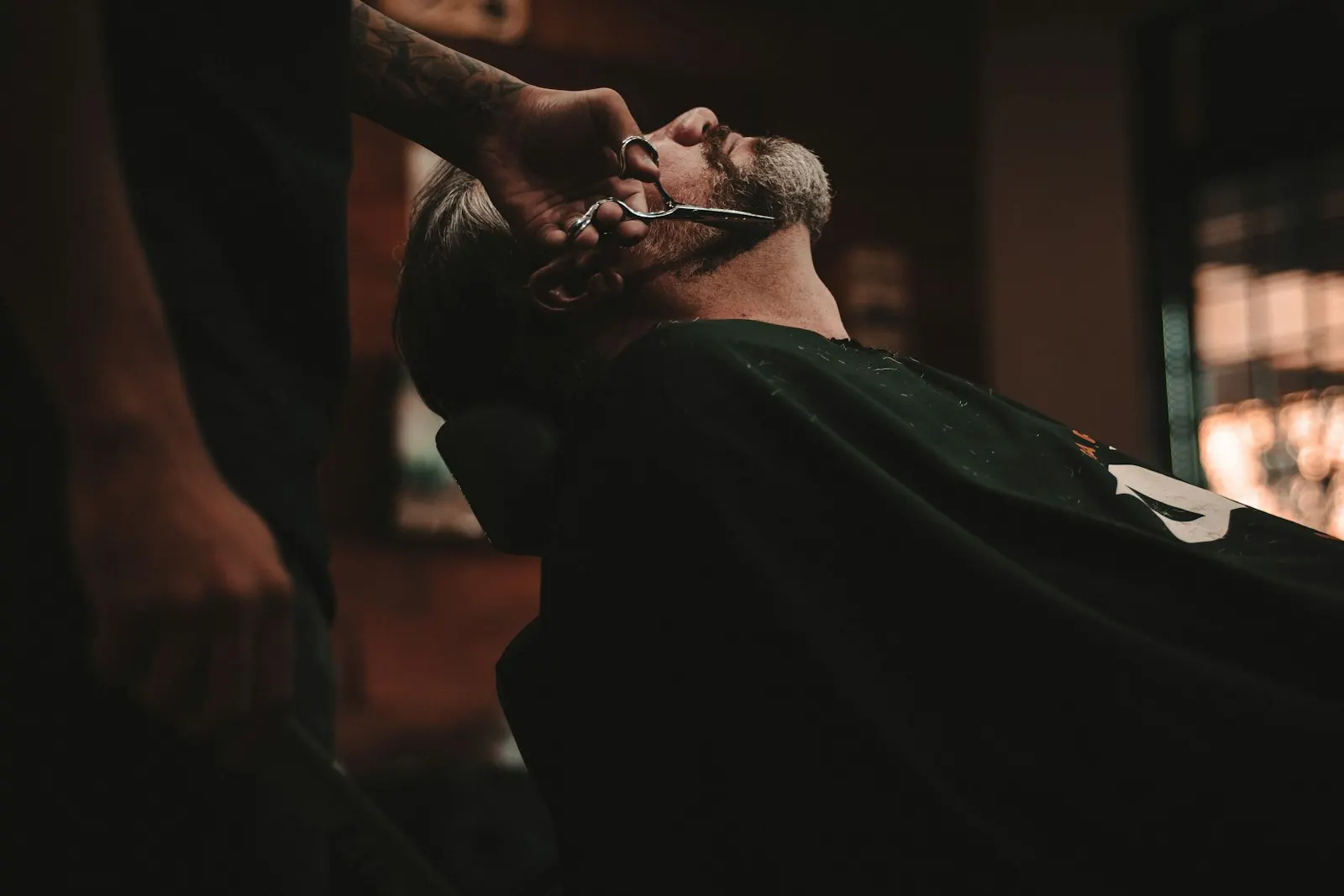 Barber working on a client in vintage barbershop
